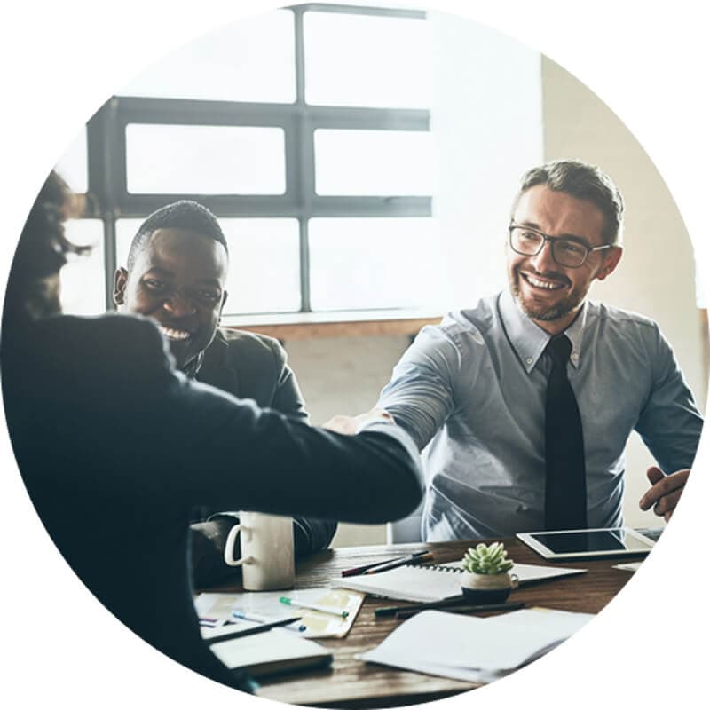 Leadership Development - humanizing your talent pipeline. Man shaking hands with boss in conference room meeting.