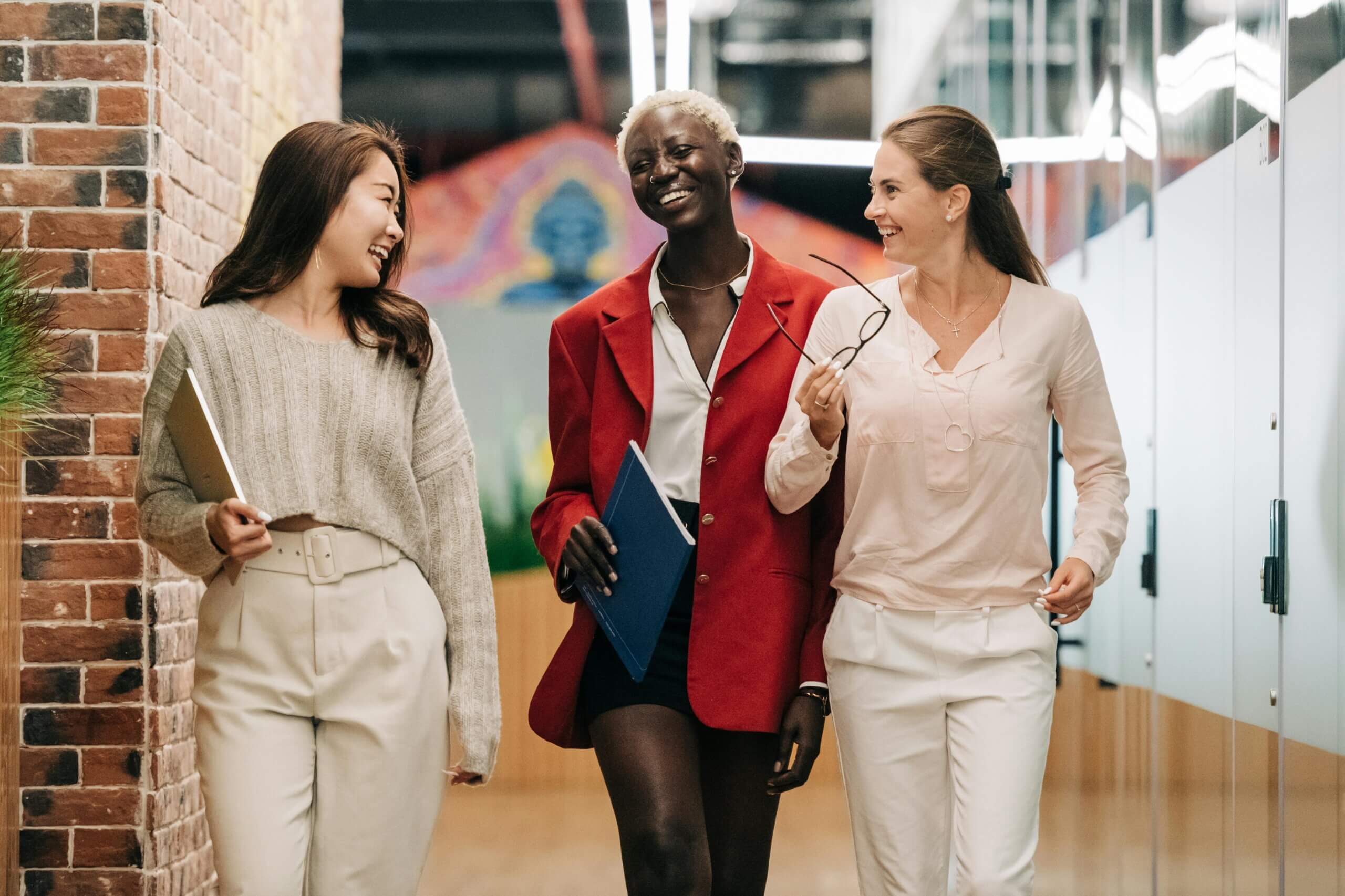 Colleagues walking together through the office