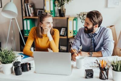 Mentor and mentee working together at a desk